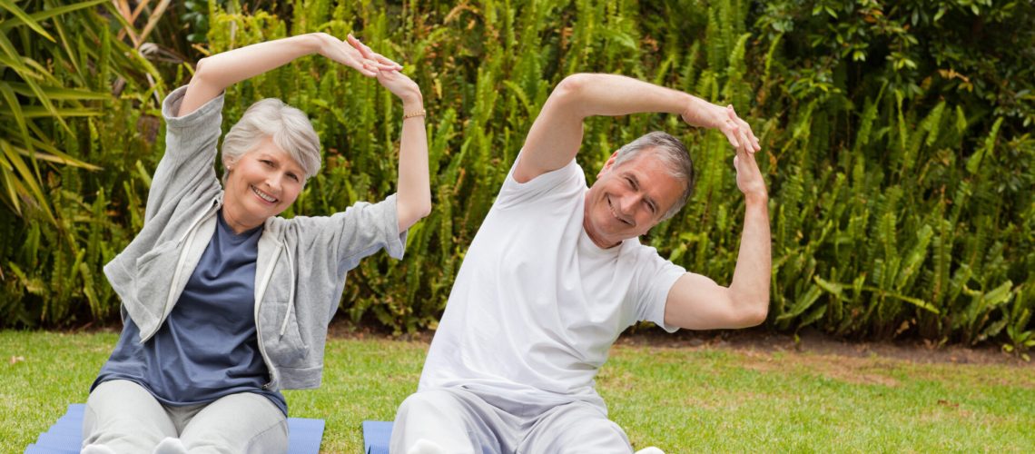 Senior couple doing their streches in the garden